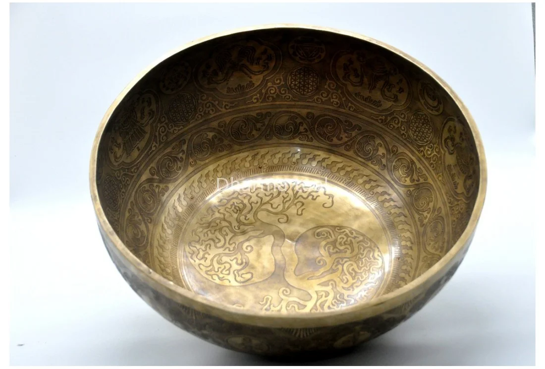 Tree of Life carved on a large Tibetan singing bowl from Nepal — roots below, branches reaching upward
