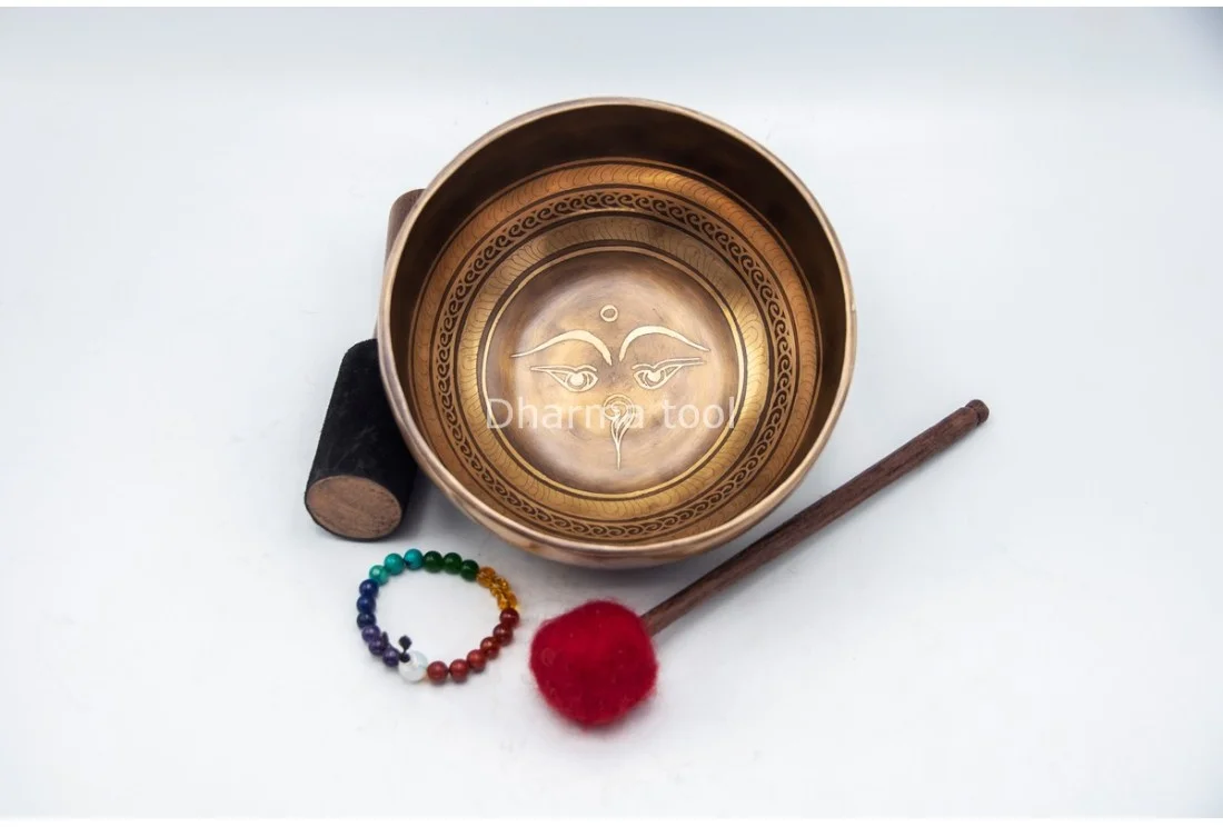 Buddha Eyes (Wisdom Eyes) etched Himalayan singing bowl from Nepal Eyes of Buddha etched on a Himalayan singing bowl — the Wisdom Eyes with third eye and Nepali unity symbol
