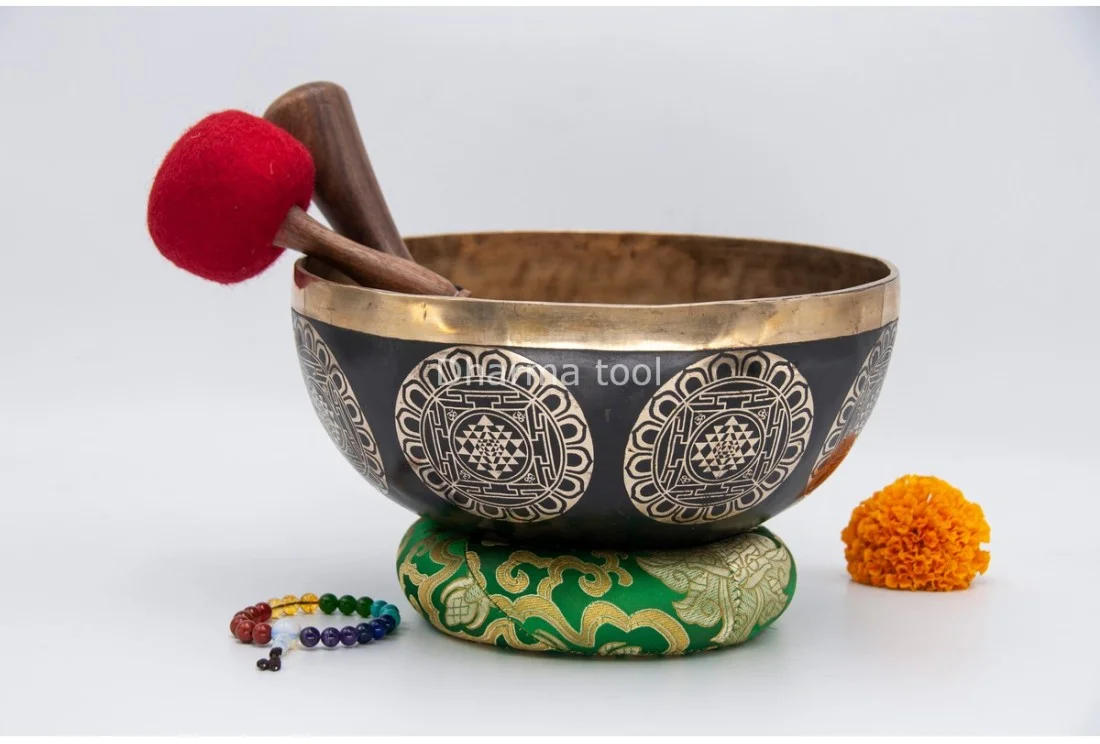 Shree Yantra carved Tibetan singing bowl — sacred geometry of the divine feminine Shree Yantra Sri Yantra carved on a Tibetan singing bowl — nine interlocking triangles around the central bindu
