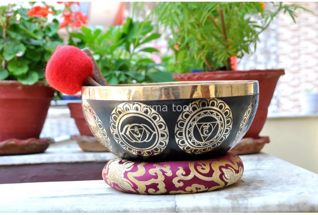 7 chakra symbol etched Tibetan singing bowl handmade in Nepal Seven chakra symbols etched around a Tibetan singing bowl — the complete energy body mapped from root to crown