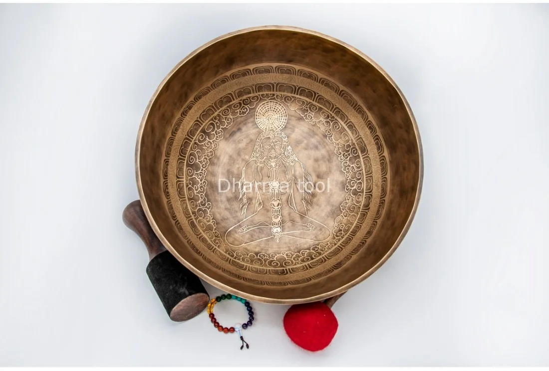 Chakra Yogi etched Himalayan singing bowl handmade in Nepal Chakra Yogi etched on a Himalayan singing bowl — meditating figure in lotus position with the seven chakra centres along the spine