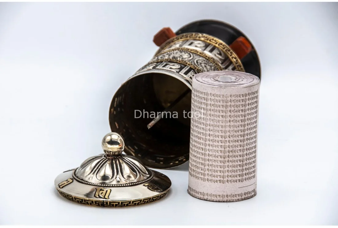 Mantra roll inside a Tibetan prayer wheel — the tightly wound paper scroll printed with Om Mani Padme Hum, revealed inside the cylinder