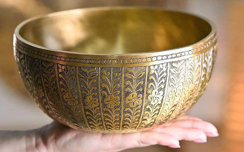 Hand Engraved Tibetan Singing Bowl Hand engraved Tibetan singing bowl with detailed carved patterns created by artisan tools on a Himalayan singing bowl