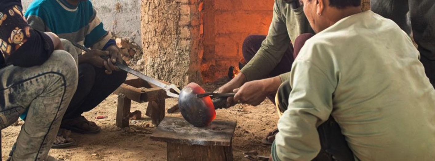 Hand hammering process of Tibetan and Himalayan singing bowl by artisans shaping metal