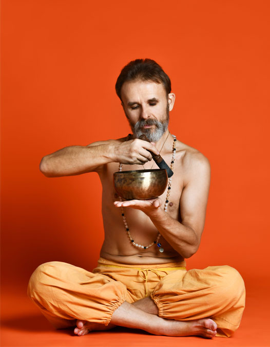 Yoga Teacher Using Singing Bowl Yoga teacher using singing bowl for meditation and sound healing