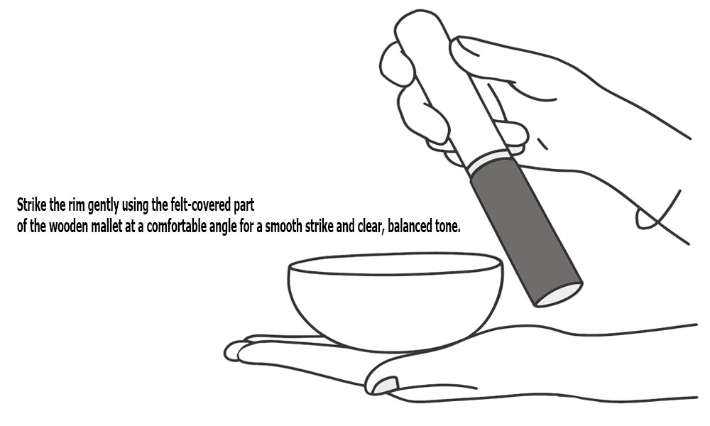 Striking singing bowl with wooden mallet