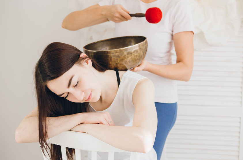How to use a Tibetan singing bowl during massage therapy session for relaxation and sound wellness