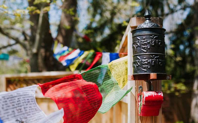 Tibetan prayer wheel placed at home entrance for protection, blessings, and positive energy