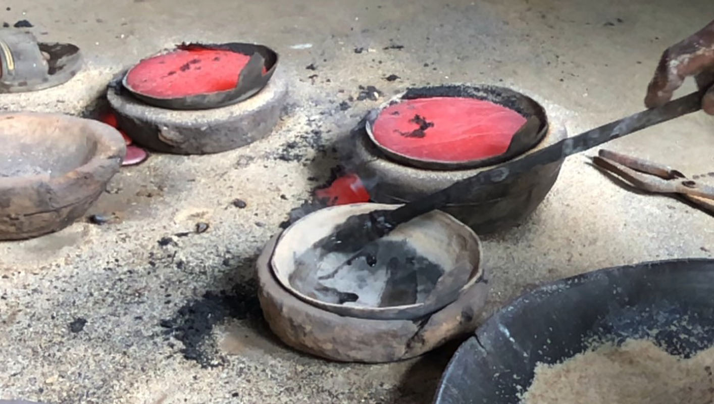 Casting molten metal into mold for Tibetan singing bowl making process